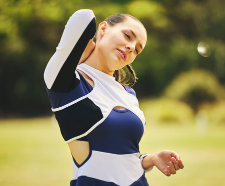 Cheerleader, fitness injury and woman neck pain from sport, training and cheer exercise on a grass field. Health, accident and muscle tension outdoor with emergency and workout challenge for wellnessの写真素材