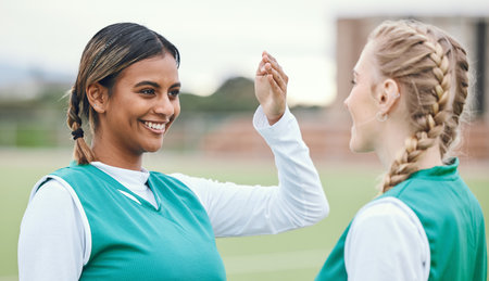 Youth, teenager and girl with smile for sports with team, practice or match on field. Female, person or student with friend in excitement, happiness or joy for game, competition or training at schoolの写真素材