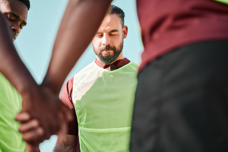 Rugby, holding hands or men with teamwork, game and training with competition, cooperation and prayer. Faith, sports and match with players, athletes or healthy group with hope, exercise and wellnessの写真素材