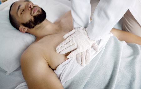 CPR, emergency and hands of doctor with patient in hospital for medical service, first aid and surgery. Healthcare, teamwork and chest compressions for injury, serious accident and wellness in clinicの写真素材