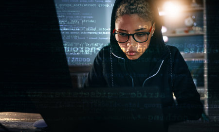 Hacker, woman in dark room with laptop and code, data analysis and IT, phishing and cyber crime with database. Cybersecurity, programming and criminal with pc, overlay or hologram with ransomwareの写真素材