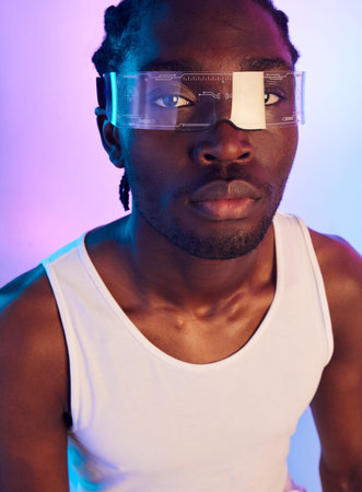 Man, vr or futuristic sunglasses in portrait for fashion, designer brand and style in studio on a neon background. Face of african person in trendy tech, virtual reality vision and metaverse glassesの写真素材