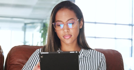 Business, office and woman with tablet, online reading and network with email notification, research and internet. Productivity, person or employee with tech, working or typing with website infoの写真素材