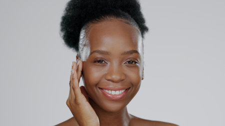 Face, skincare and hands of happy black woman in studio isolated on gray background mockup space. Portrait, natural cosmetics and African model touch skin in spa facial treatment, wellness or healthの写真素材