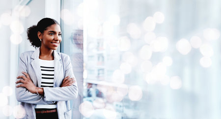 Black woman, arms crossed and thinking with a smile from business consultant work with mockup space. Ideas, female entrepreneur and professional from New York happy from startup by window bokehの写真素材