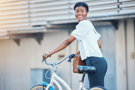Black woman, bicycle commute and business on road in city with sustainability travel, ride and morning with smile. Happy worker, female professional and employee with bike for carbon footprintの写真素材