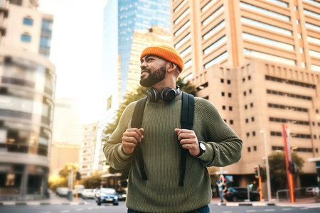 Man in city, backpack and smile on morning commute to university campus for education with buildings. Opportunity, study and happy gen z college student, walking on urban street and travel to school.の写真素材