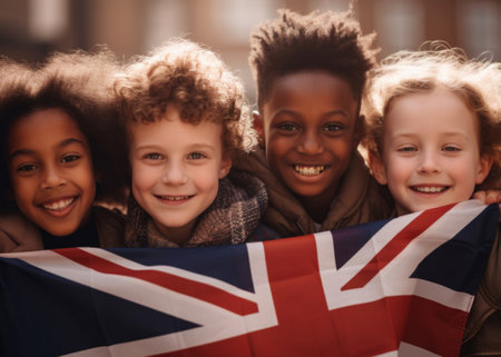 Group of diverse kids holding a flag. Educate and celebrate different nationalities and countriesの素材