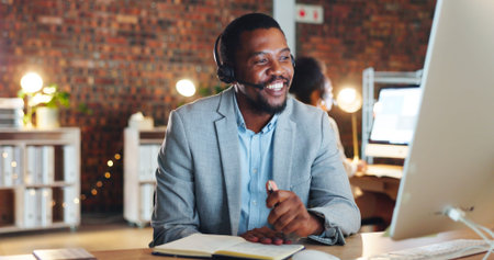 African man, call center and computer in office, talk and night for telemarketing, voip mic and...