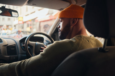 Driving, travel and man in a car for transportation, location search and in traffic in the morning. Thinking, driver and a person on a journey in transport for a commute or parking in the streetの写真素材