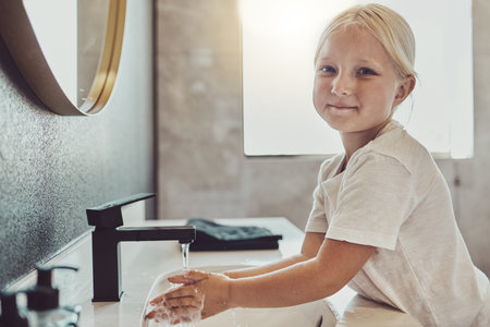 Bathroom, water and portrait of child washing hands with soap, foam and healthy hygiene. Cleaning...