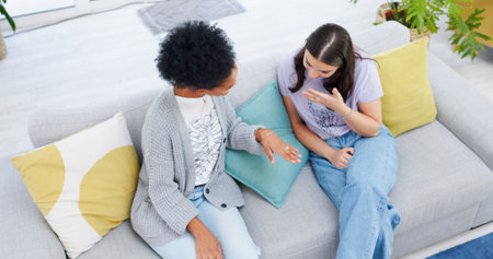 Engagement, ring and woman show friends, jewelry and girls excited for wedding, commitment or marriage . Hand, diamond and above happy women on sofa with surprise, announcement and news of fianceの写真素材