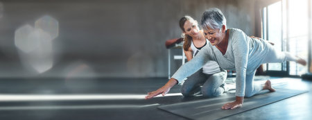 Exercise, mockup and mature woman in gym with personal trainer workout, help and stretching on banner. Info space, fitness and senior person with physio floor challenge, coaching motivation and bokehの写真素材
