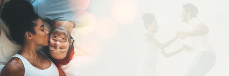 Double exposure, kiss and couple on bed for love and playing together in the morning in a bedroom for happiness. Jumping, care and playful happy man excited with woman in a home with romanceの写真素材