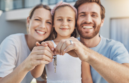Home keys, parents or portrait of happy family with child or smile in new house, apartment or real estate. Hands, excited mother or proud father with a girl or kid moving into property investmentの写真素材