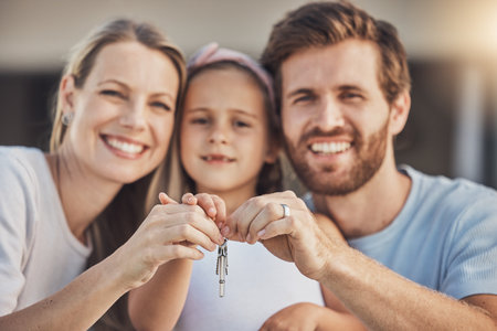 Happy family, portrait and kid with keys for real estate success, new home and moving achievement with love. Face of mother, father and girl child with property investment, mortgage or outdoor houseの写真素材