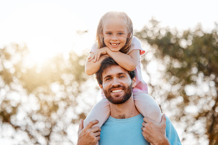 Nature, happy and portrait of father with child in an outdoor park playing, bonding and having fun. Happiness, smile and girl kid on the shoulder of young dad from Australia in garden together.の写真素材
