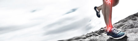Banner, runner and training with injury on leg for anatomy for joint pain in closeup, overlay and mockup. Person, healthcare or medical in sports, fitness or workout on terrain, wellness or roadの写真素材