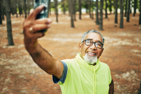 Selfie, smile and senior man hiking for health, wellness or cardio training on a mountain. Happy,...