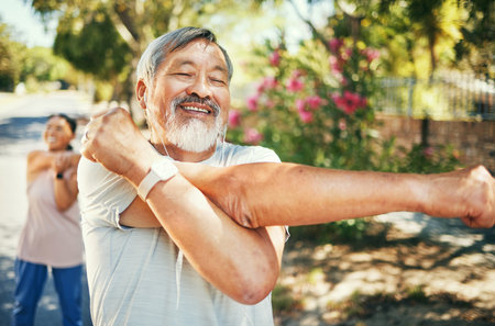 Man, happy and stretching arms for run outside, earphones and listening to music, audio and song for motivation. Healthy friends, cardio and training in retirement, workout and exercise in warm upの写真素材