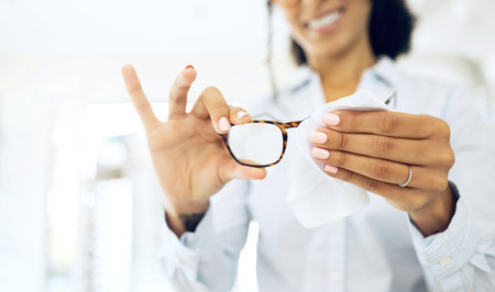 Hands, woman is cleaning glasses with fabric and hygiene, vision and eye care with health and...