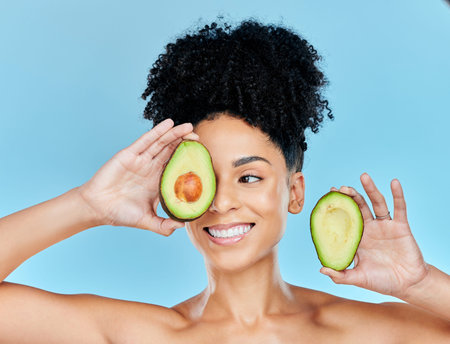 Avocado, skincare and beauty, woman with natural benefits and product for face on blue background....