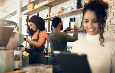 Happy woman, tablet and team in small business at cafe for hospitality service at coffee shop. Female person, entrepreneur or restaurant owner smile with technology and barista in teamwork at storeの写真素材