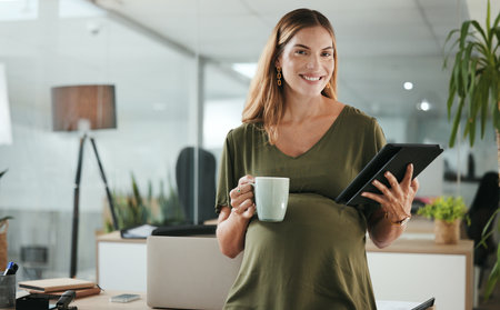 Portrait, tablet and pregnant with woman in her business office at the start of her maternity leave from work. Company, research and pregnancy with tea and happy young employee in the workplaceの写真素材