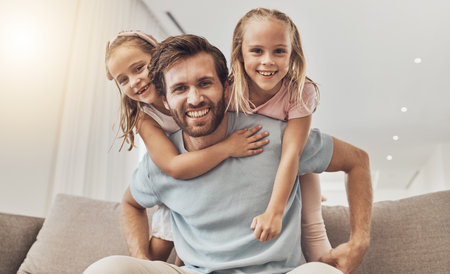 Portrait, piggyback and girl kids with father on a sofa smile, bond and playing in their home together. Love, happy family and excited children hug parent in a living room with care, support and funの写真素材