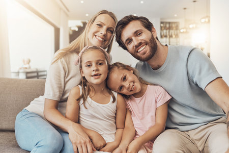 Home, portrait and mother with father, kids and happiness with support, bonding together and cheerful. Face, family and children with parents, care and love with a smile, cheerful and joy in a loungeの写真素材