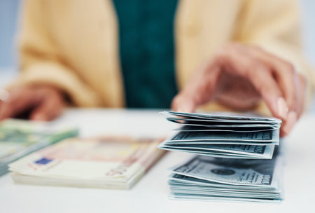 Hands, finance and a business person counting cash closeup in the office of a bank for accounting....