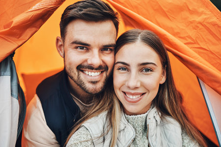 Happy couple, face and portrait in tent for camping, holiday vacation or travel together on outdoor adventure. Man and woman smile in relationship for weekend on camp site, journey or love in natureの写真素材