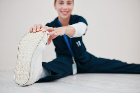 Feet, stretching and nurse with legs on floor in exercise at the start of shift in healthcare,...