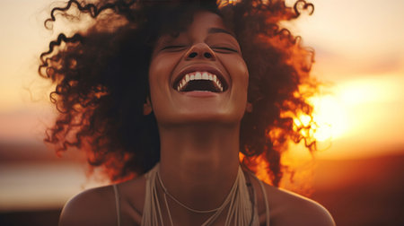 Happy young woman at sunset..Laughing, enjoying life. Golden hour concept.の素材