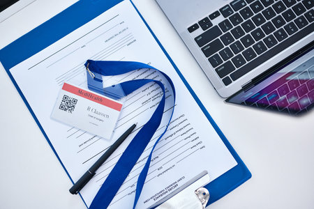 Above shot, insurance form and documents with laptop, name tag and form for medical assistance,...