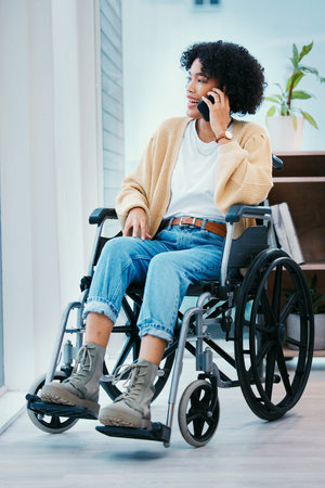 Phone call, wheelchair and happy woman talking in home, chat and speaking. Mobile, conversation and smile of person with a disability, online communication and smartphone technology for discussionの写真素材