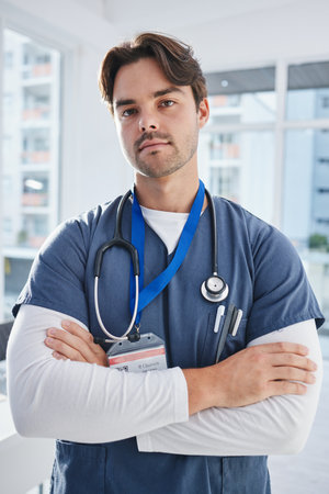 Hospital portrait, arms crossed and serious man, doctor or nurse with confidence, pride and medical expertise. Healthcare, medicine clinic trust and professional medic for cardiology support helpの写真素材