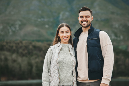 Hiking, couple and portrait outdoor with vacation and trekking together with love in winter. Mountain, holiday and travel in the morning with happy woman and man on adventure in nature with a smileの写真素材