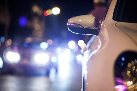Car, traffic and road at night with bokeh for transportation, asphalt and lights in an urban town. City street, taxi and travel or driving in glow for journey, commute or moving on the highwayの写真素材