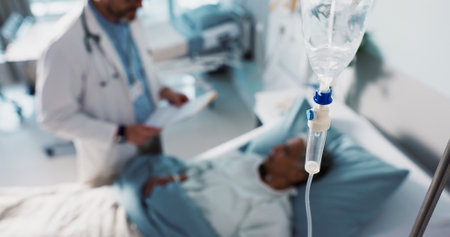 IV drip, healthcare and medicine with doctor and patient in hospital, treatment and surgery with healing. People at clinic, health with medication or liquid in bag for infusion, service and recoveryの写真素材