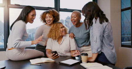 Teamwork, happy or business women with phone for gossip news, social media or blog content reading In office. Friends, startup or group of employee on smartphone smile for networking or communicationの写真素材