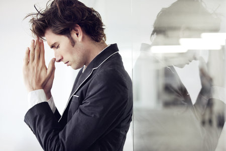 Praying, religion and young man in a studio with double exposure for gratitude, hope or worship. Trust, compassion and male model from Canada with regret or mistake isolated by white background.の写真素材