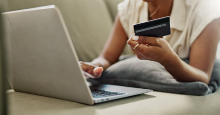 Credit Card, laptop and hands of person online shopping for discount, fintech service or ecommerce sales. Web store search, savings transfer payment and closeup customer banking on home lounge sofaの写真素材