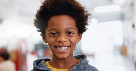 Portrait, boy or child with education for learning, knowledge and study with smile and confidence. Face, student or kid with happiness at school or classroom for scholarship or development at academyの写真素材