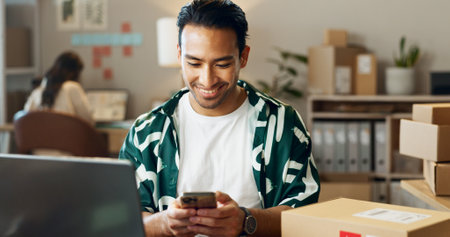 Happy asian man, phone and logistics for communication, social media or online order at boutique. Male person or delivery with smile and mobile smartphone for networking in small business at storeの写真素材