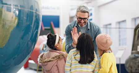 Science, high five and students learning about the earth with a teacher at school for child...