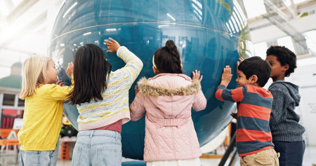 Children, world map and geography for learning, earth and school classroom. Kindergarten, students and happiness for innovation, planet and science for future, child development and stem educationの写真素材