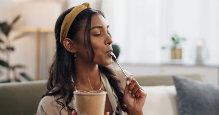 Woman, eating ice cream and sofa in house, thinking or idea for dessert, sweets or relax in living...