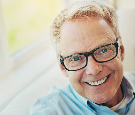 Portrait, glasses or happy mature man in house living room to relax with care on sofa for resting...