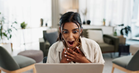 Excited woman, laptop and surprise for good news, winning or bonus promotion at home office. Shocked...